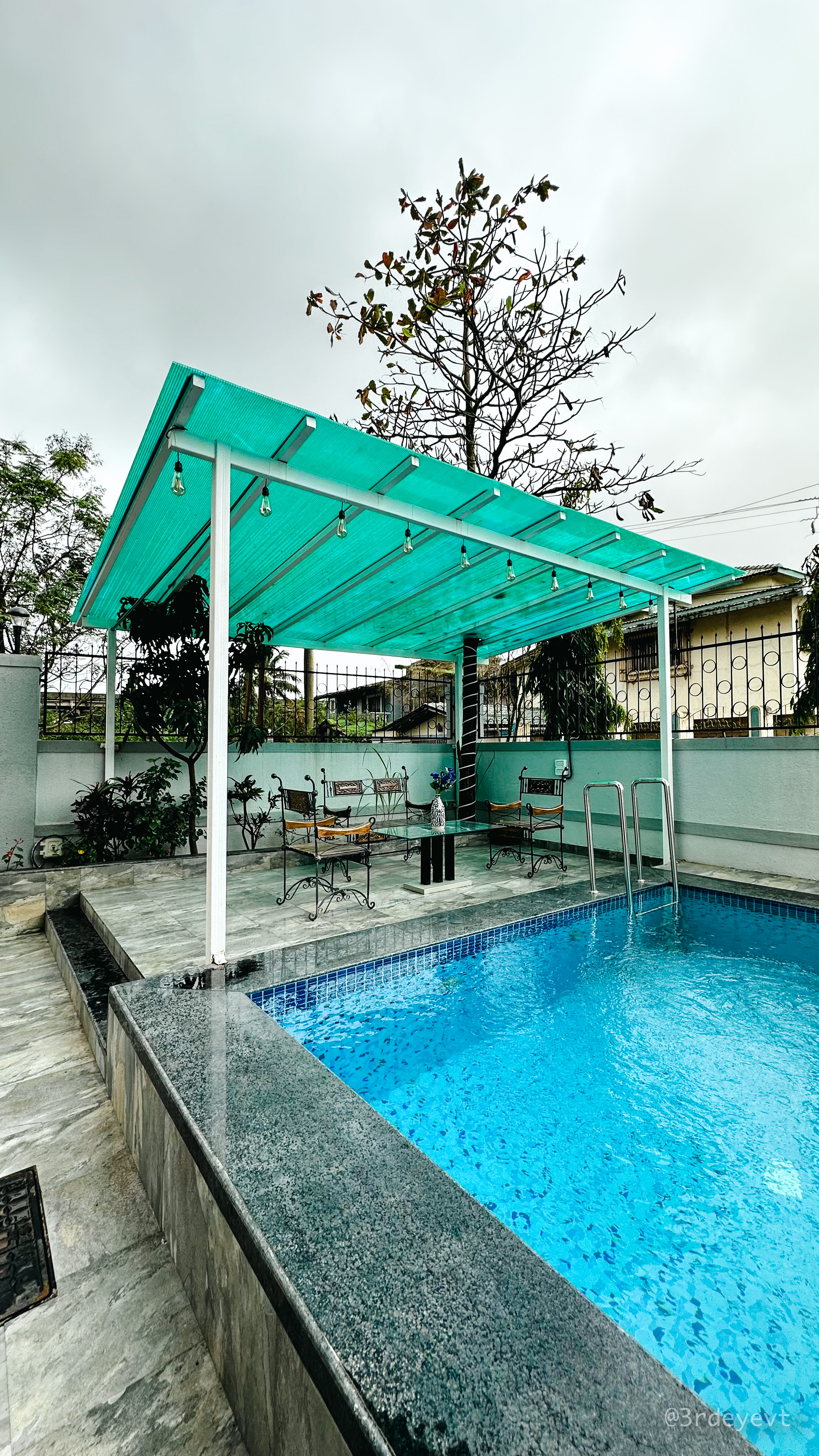 Covered outdoor seating beside the villa's private pool